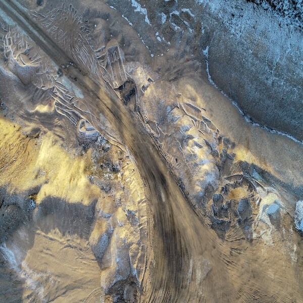 Aerial view of a mine site with dirt tracks and pathways,